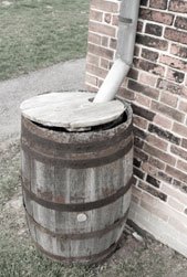 Example of how alternate water sources, rain barrel at end of gutter.