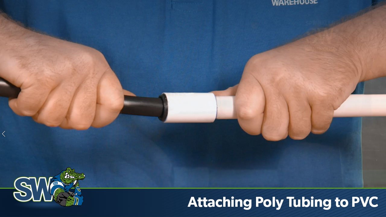 This image shows the Sprinkler Warehouse Pro pushing poly tubing into a compression fitting to attach poly to PVC pipe.
