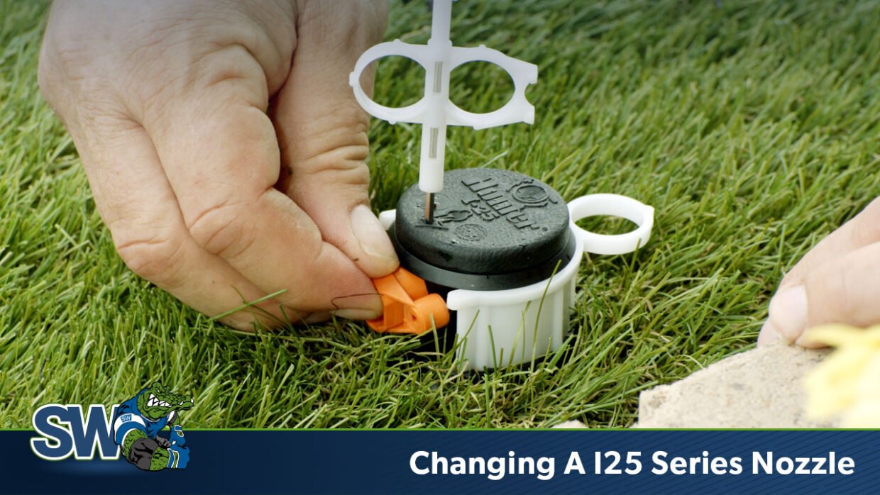 This is a picture of the I25 rotary spray head being adjusted by a hand holding a rotor tool.
