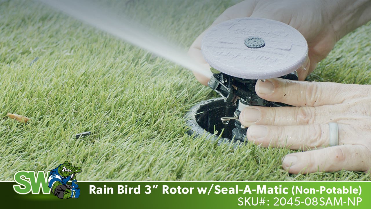 This image shows the Maxi-Paw Non-Potable Rotor from Rain Bird being adjusted in the grass with water spraying out.