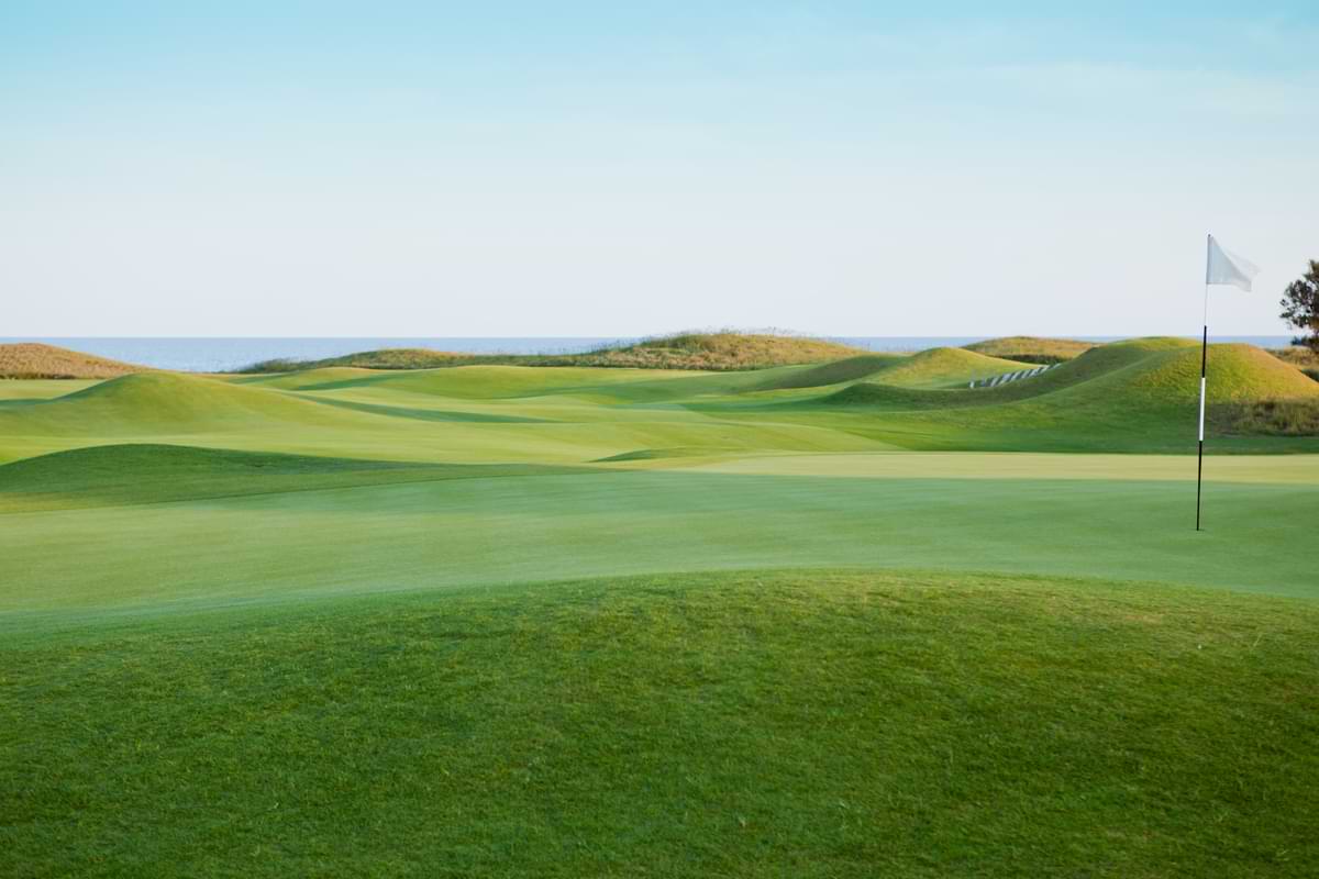 Golf Course Irrigation: Make Your System a Hole-in-One 3 Verdant, green golf course on a beautiful day with a picturesque blue sky back drop.