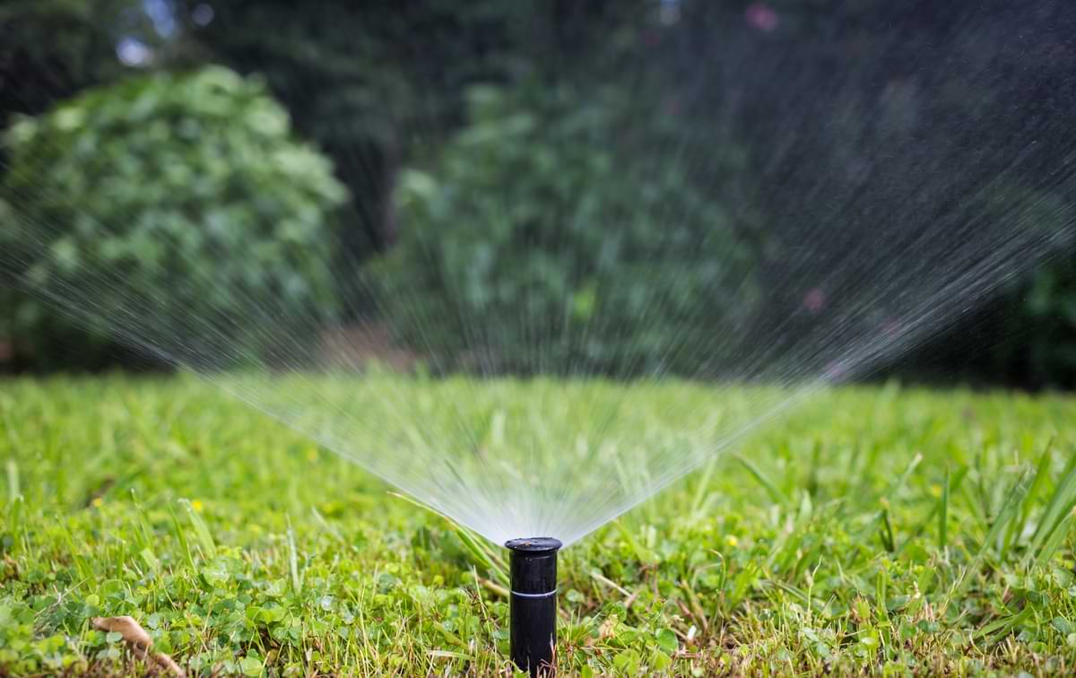 Irrigation Systems for Different Soil Types 1 Gear driven sprinkler watering grass.