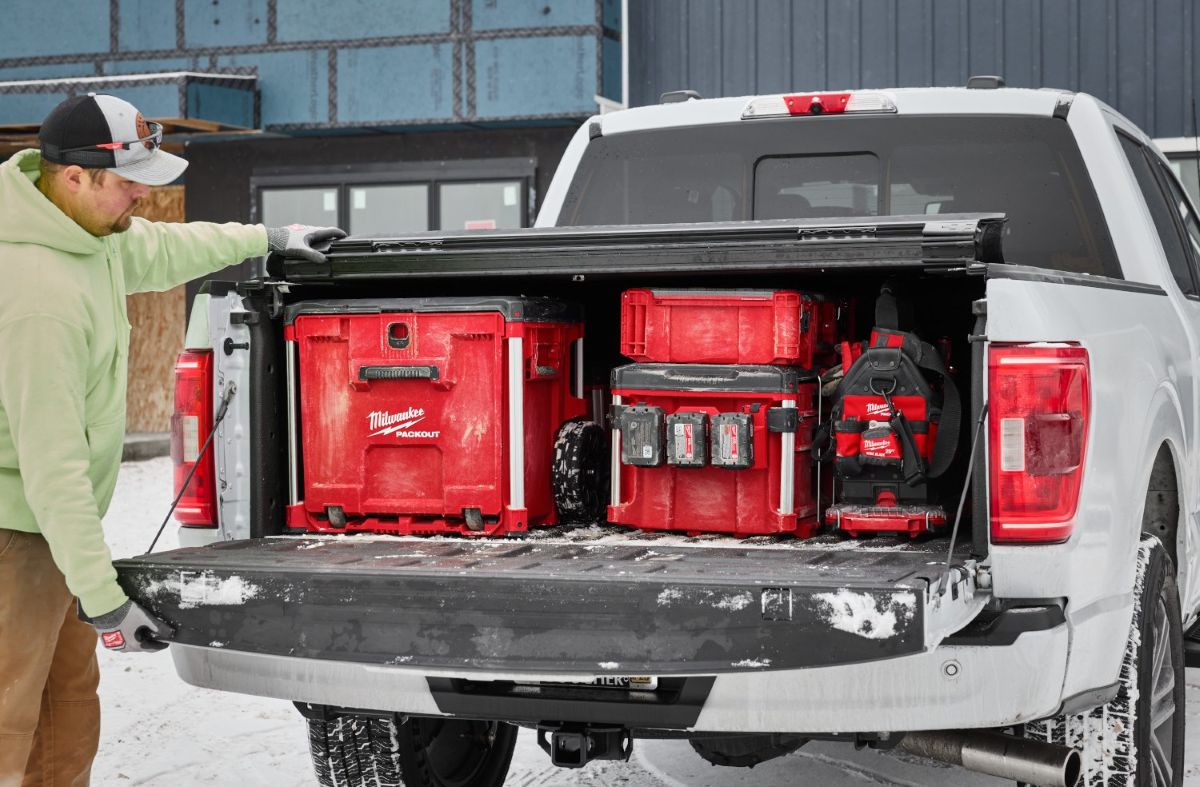 Milwaukee PACKOUT™ Guide: Work Smarter with Milwaukee Box Tools 1 Man loading Milwaukee PACKOUT toolboxes in the bed of his pickup truck.